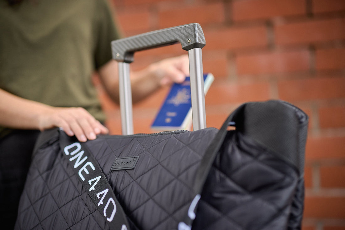 one440 bag attached to a carry on bag handle